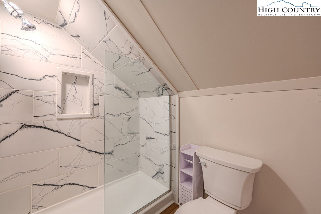 1821 Deerfield Road Boone, NC 28607 - Photo 32 of 33 a bathroom with a toilet and shower