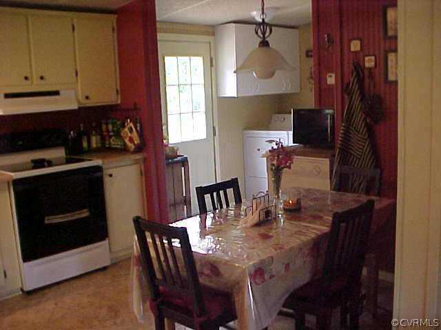 1223 Mt Pleasant Road Pamplin, VA 23958 - Photo 4 of 10 a view of a dining room with furniture and wooden floor
