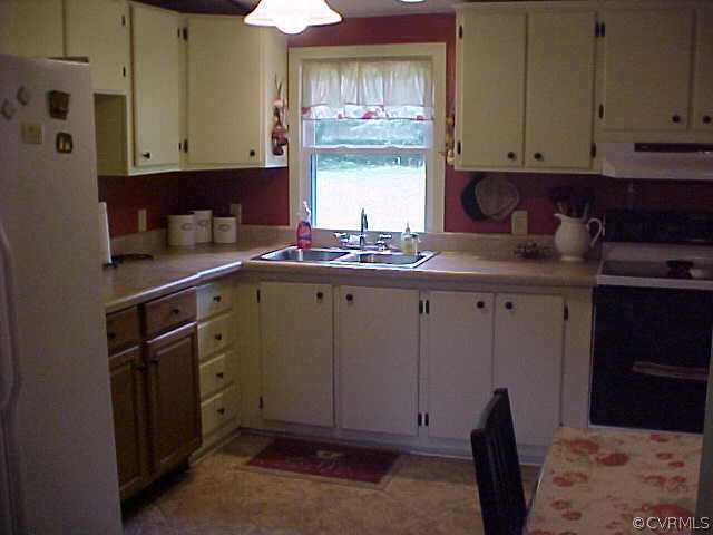 1223 Mt Pleasant Road Pamplin, VA 23958 - Photo 5 of 10 a kitchen with cabinets appliances and a window