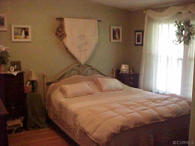 1223 Mt Pleasant Road Pamplin, VA 23958 - Photo 7 of 10 a bedroom with a bed and wooden floor