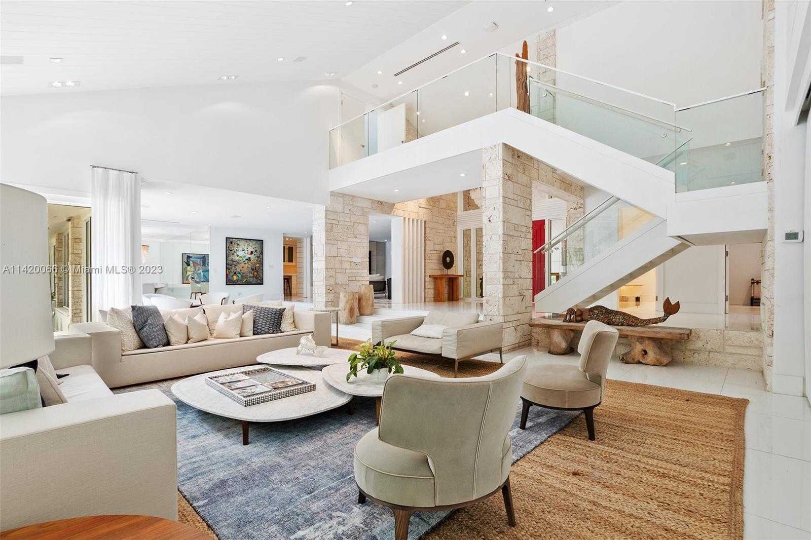 a living room with patio furniture and a rug