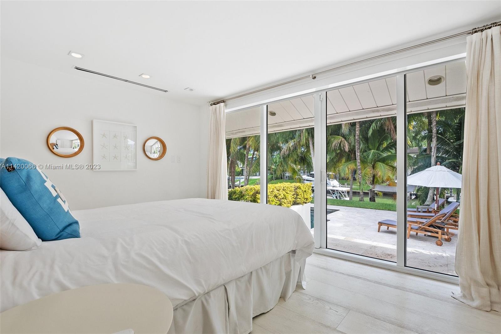 700 Lake Road Miami, FL 33137 - Photo 21 of 59 a bed sitting in a bedroom next to a window