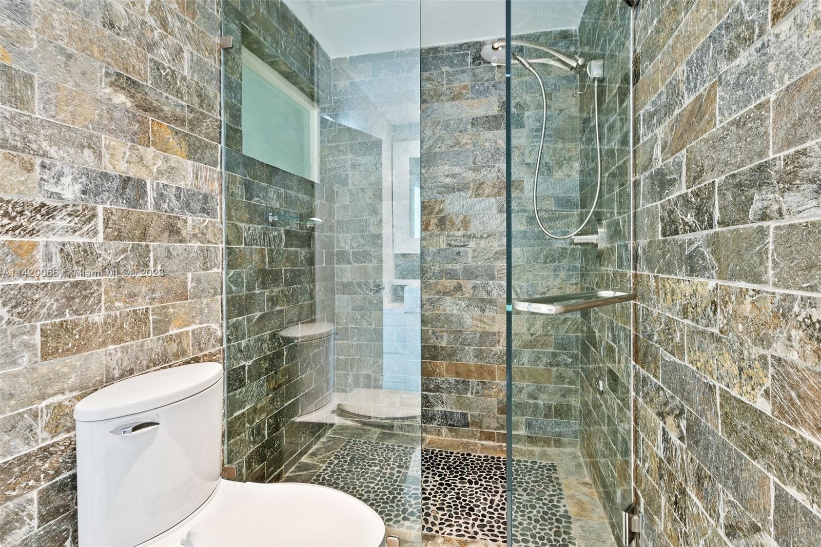 700 Lake Road Miami, FL 33137 - Photo 23 of 59 a bathroom with a shower and toilet