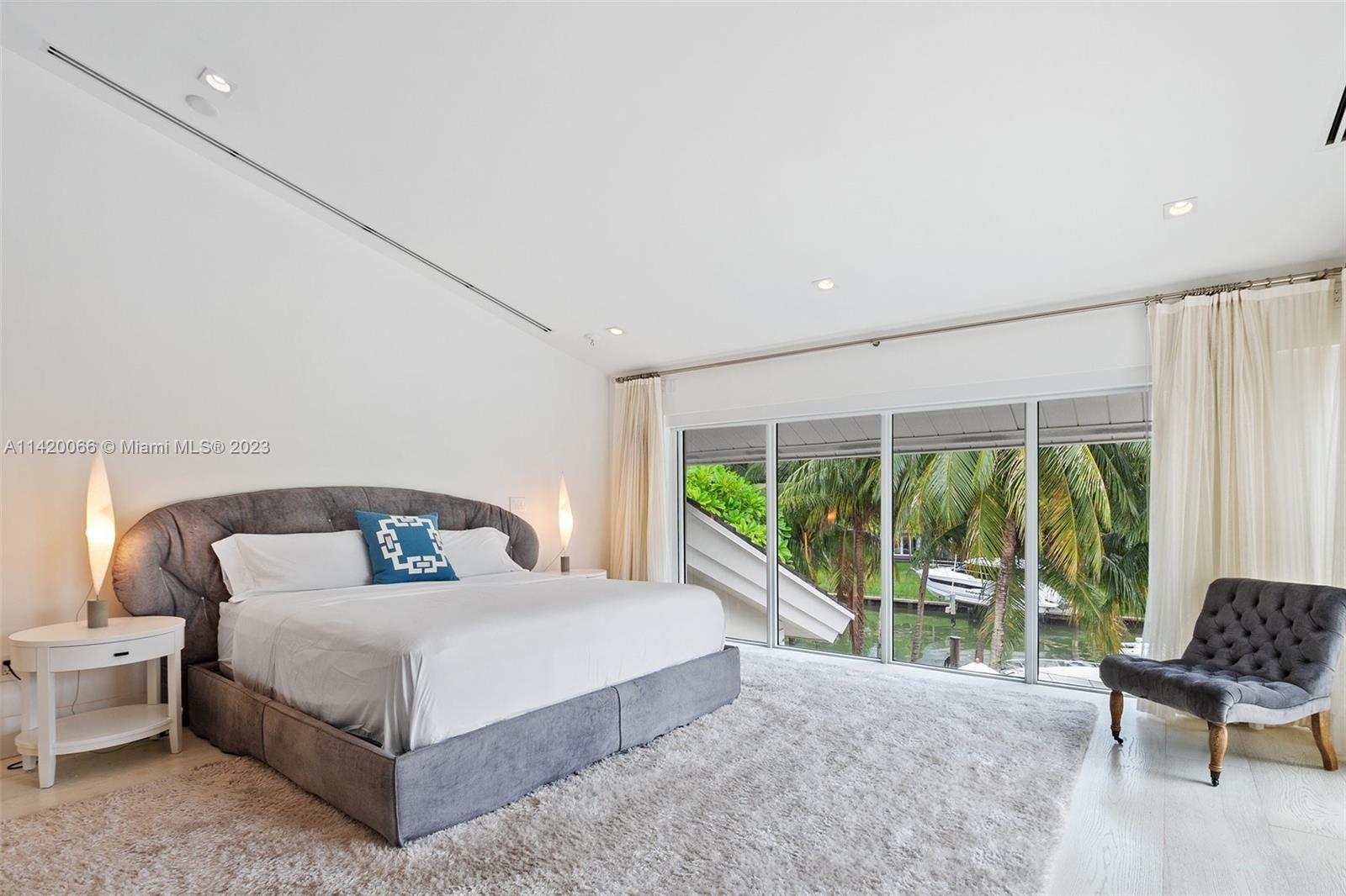 700 Lake Road Miami, FL 33137 - Photo 32 of 59 a bedroom with a bed and a large window