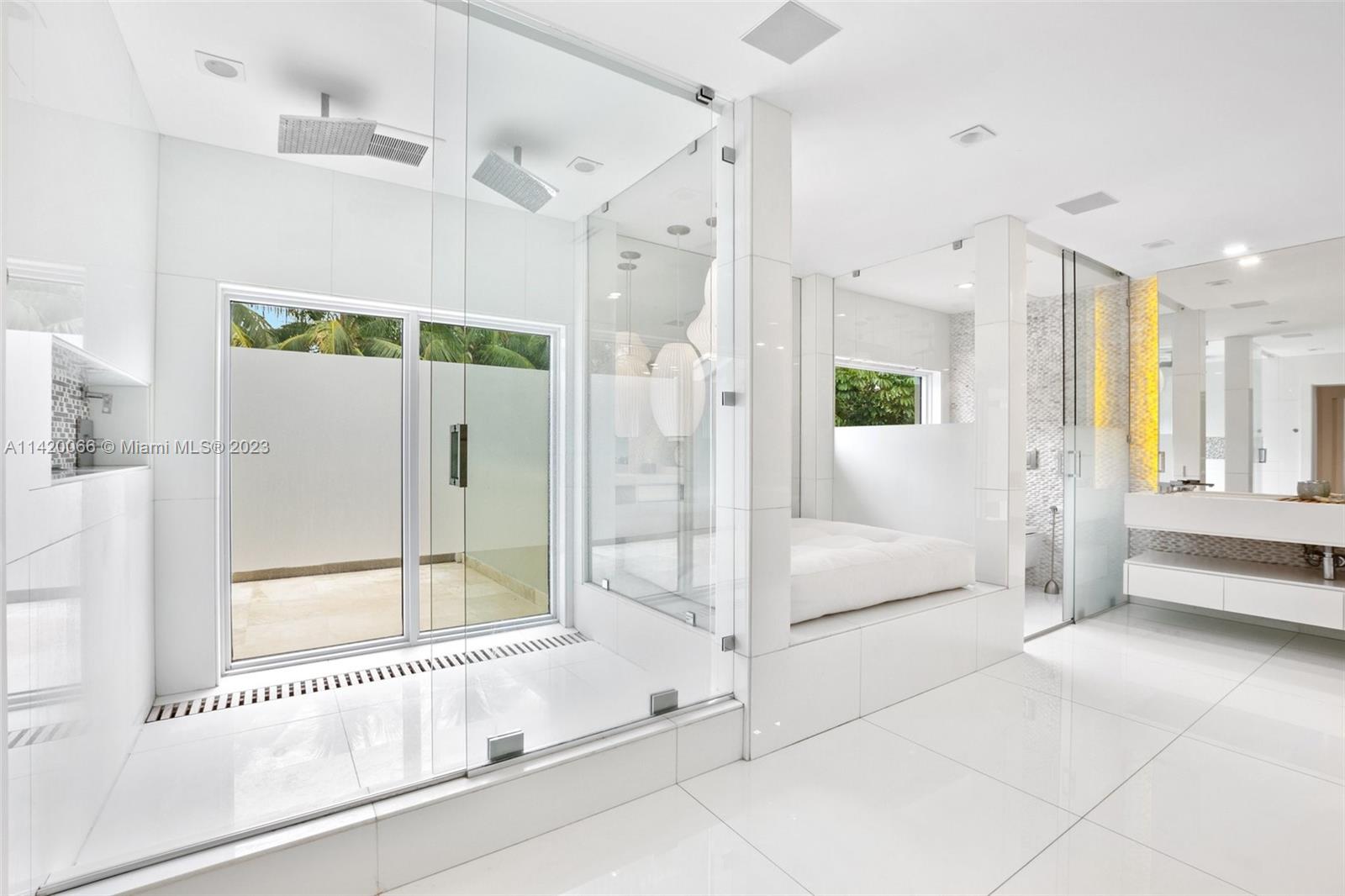 700 Lake Road Miami, FL 33137 - Photo 36 of 59 a spacious bathroom with a glass shower door and a bathtub