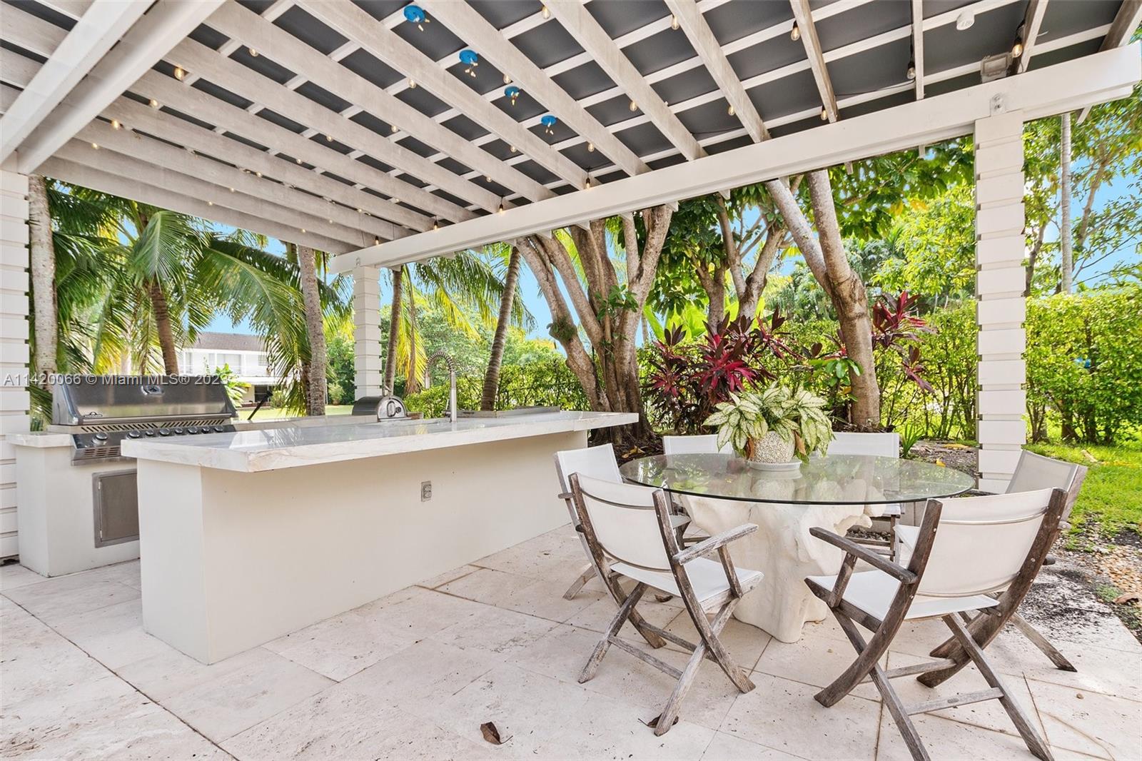 700 Lake Road Miami, FL 33137 - Photo 43 of 59 a dining room with stainless steel appliances granite countertop a stove and chairs