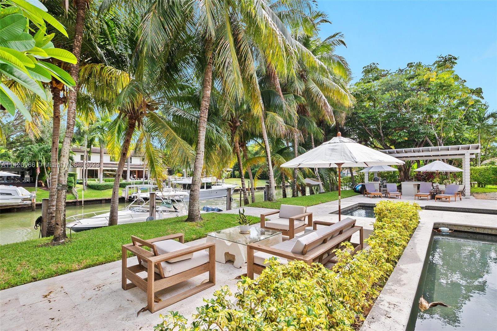 700 Lake Road Miami, FL 33137 - Photo 45 of 59 an outdoor space with patio and white umbrellas