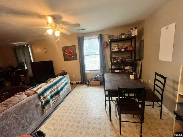 a living room with furniture a desk and bookshelf