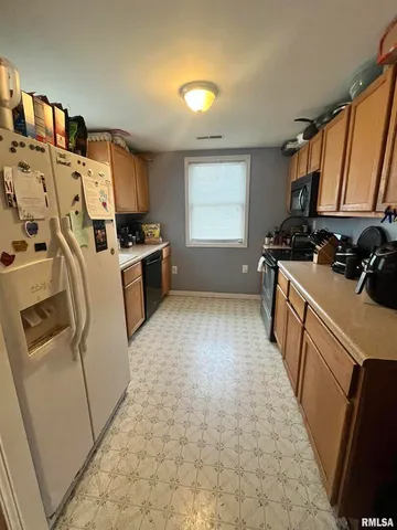 a kitchen with stainless steel appliances a stove a sink and a refrigerator