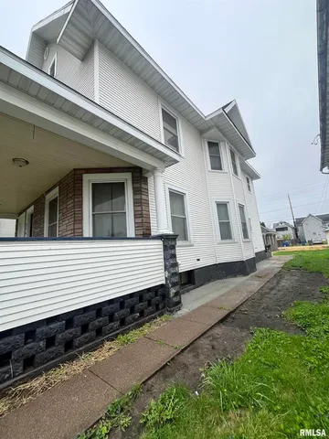 a side view of a house with a yard