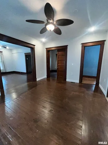 a view of an empty room and wooden floor