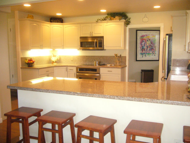 414 Locke Drive Aptos, CA 95003 - Photo 5 of 11 a kitchen with stainless steel appliances granite countertop a sink and a stove top oven with wooden floor