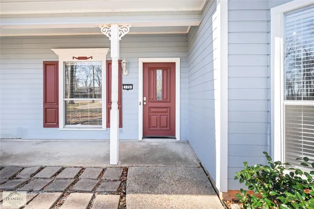 a view of an entryway with wooden floor