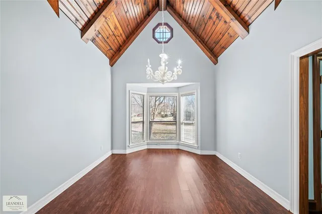 a large kitchen with a lot of counter space and wooden floor