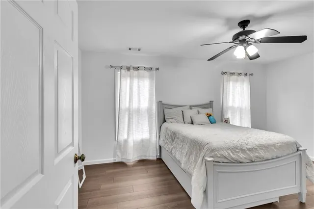 a large bedroom with a bed and a window