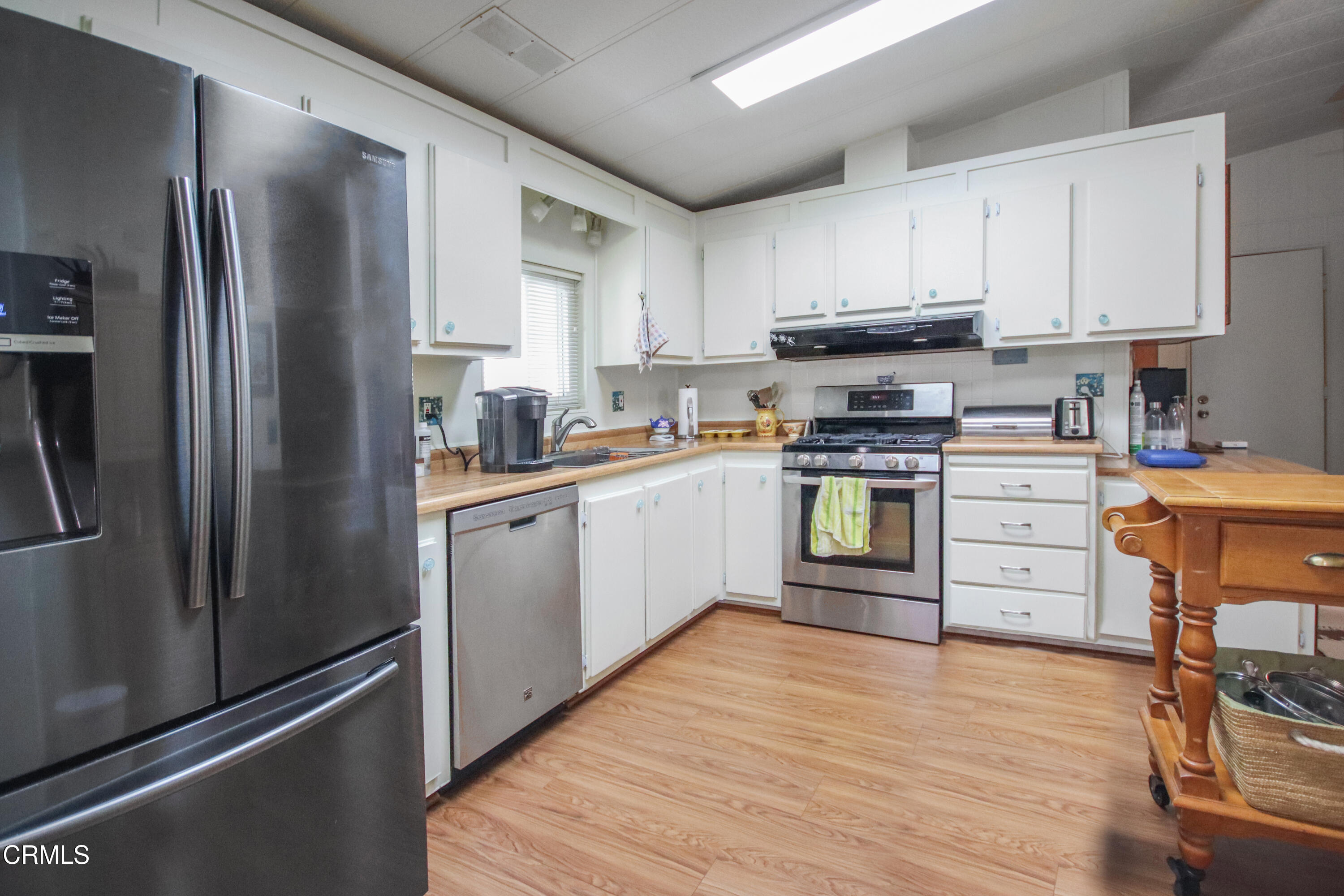 440 Dewberry Lane, Unit 105 Oxnard, CA 93036 - Photo 13 of 75 a kitchen with white cabinets stainless steel appliances and a window