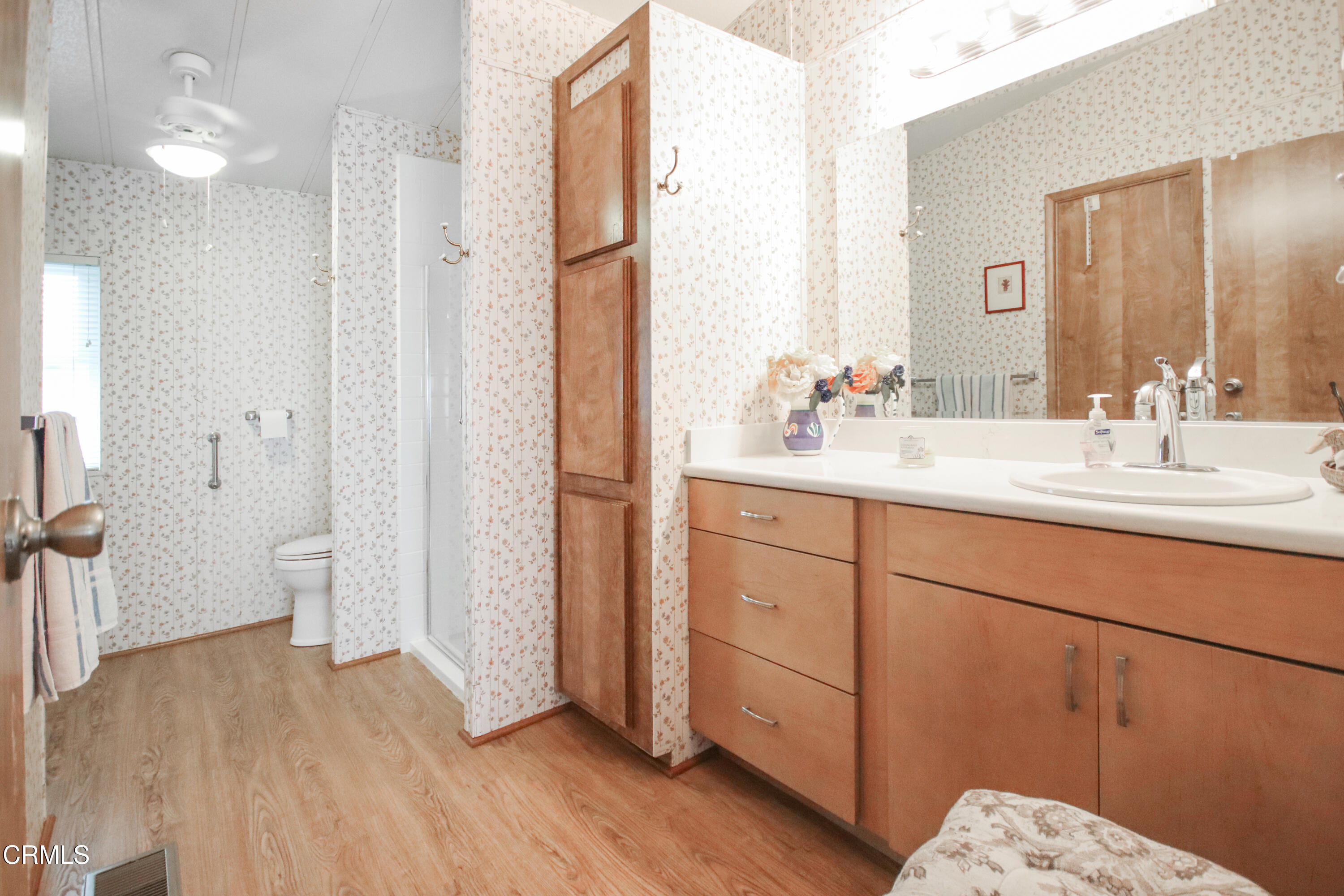 440 Dewberry Lane, Unit 105 Oxnard, CA 93036 - Photo 16 of 75 a en suite bathroom with a double vanity sink a toilet and a mirror
