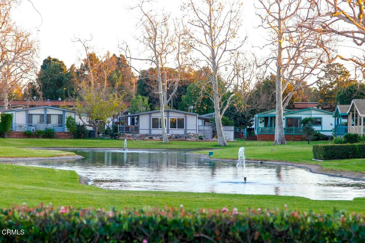 440 Dewberry Lane, Unit 105 Oxnard, CA 93036 - Photo 33 of 75 a view of a house with a big yard and potted plants and large trees