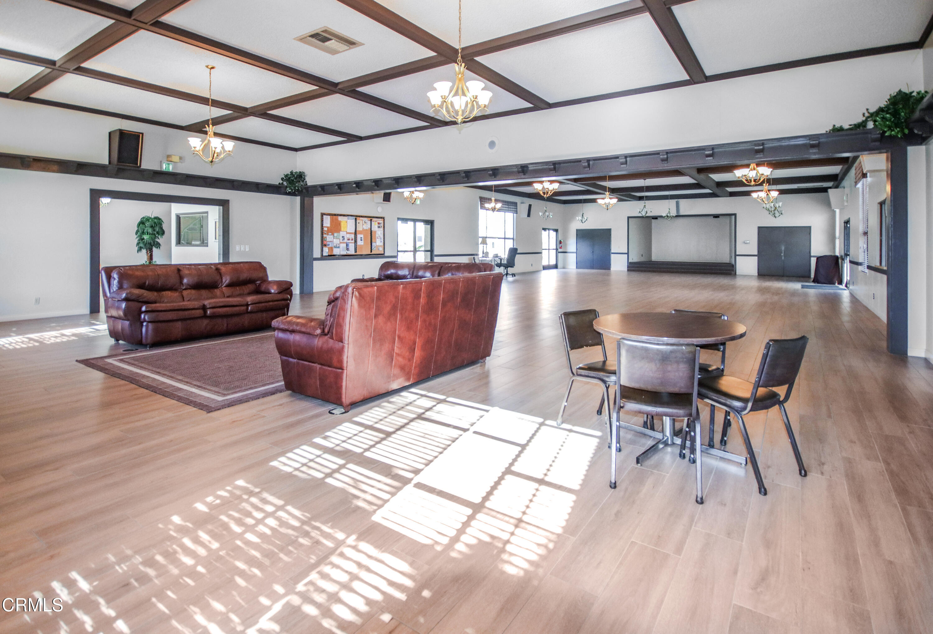 440 Dewberry Lane, Unit 105 Oxnard, CA 93036 - Photo 35 of 75 a living room with furniture and a chandelier