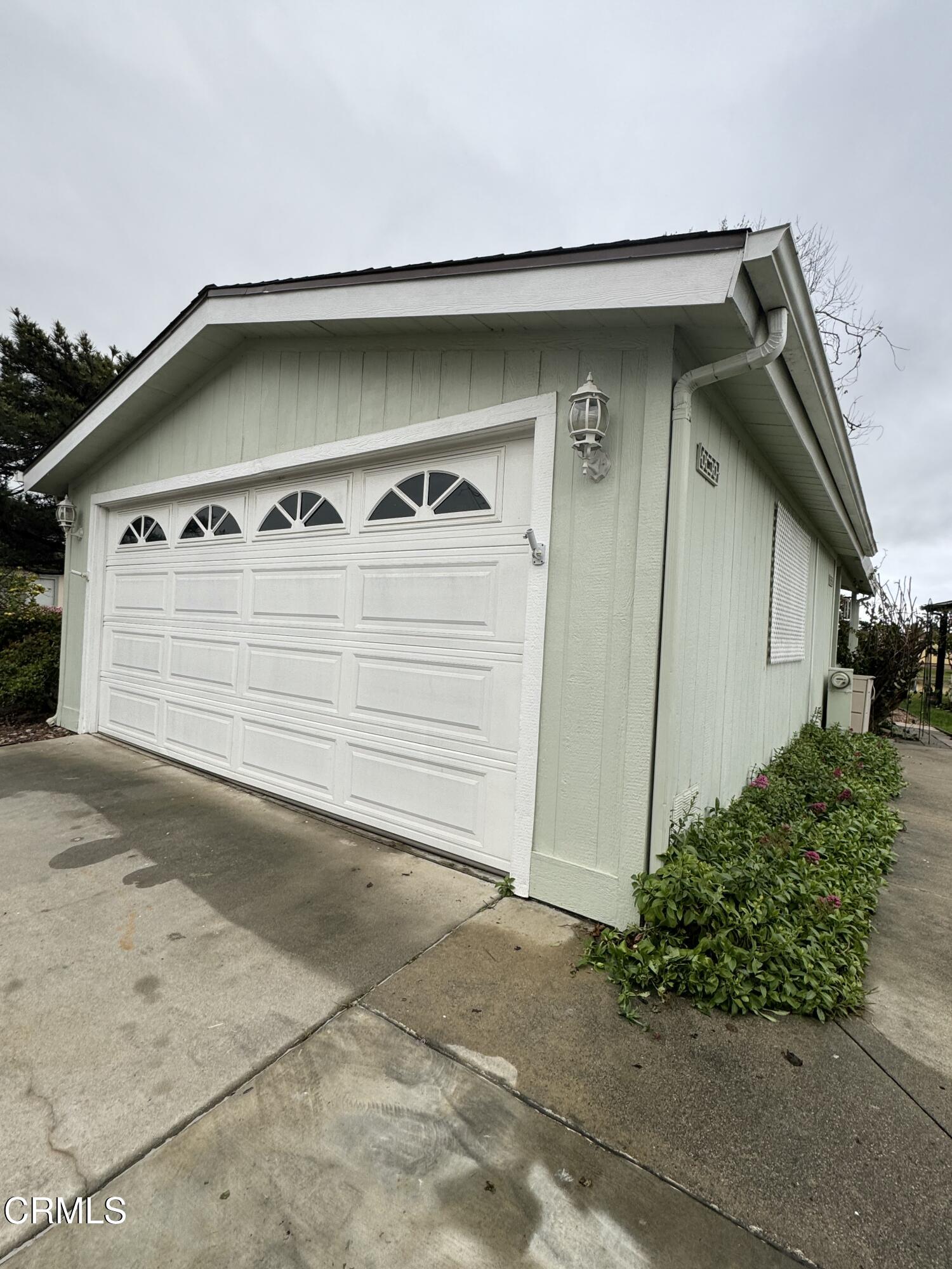440 Dewberry Lane, Unit 105 Oxnard, CA 93036 - Photo 57 of 75 a view of a house with a yard and garage