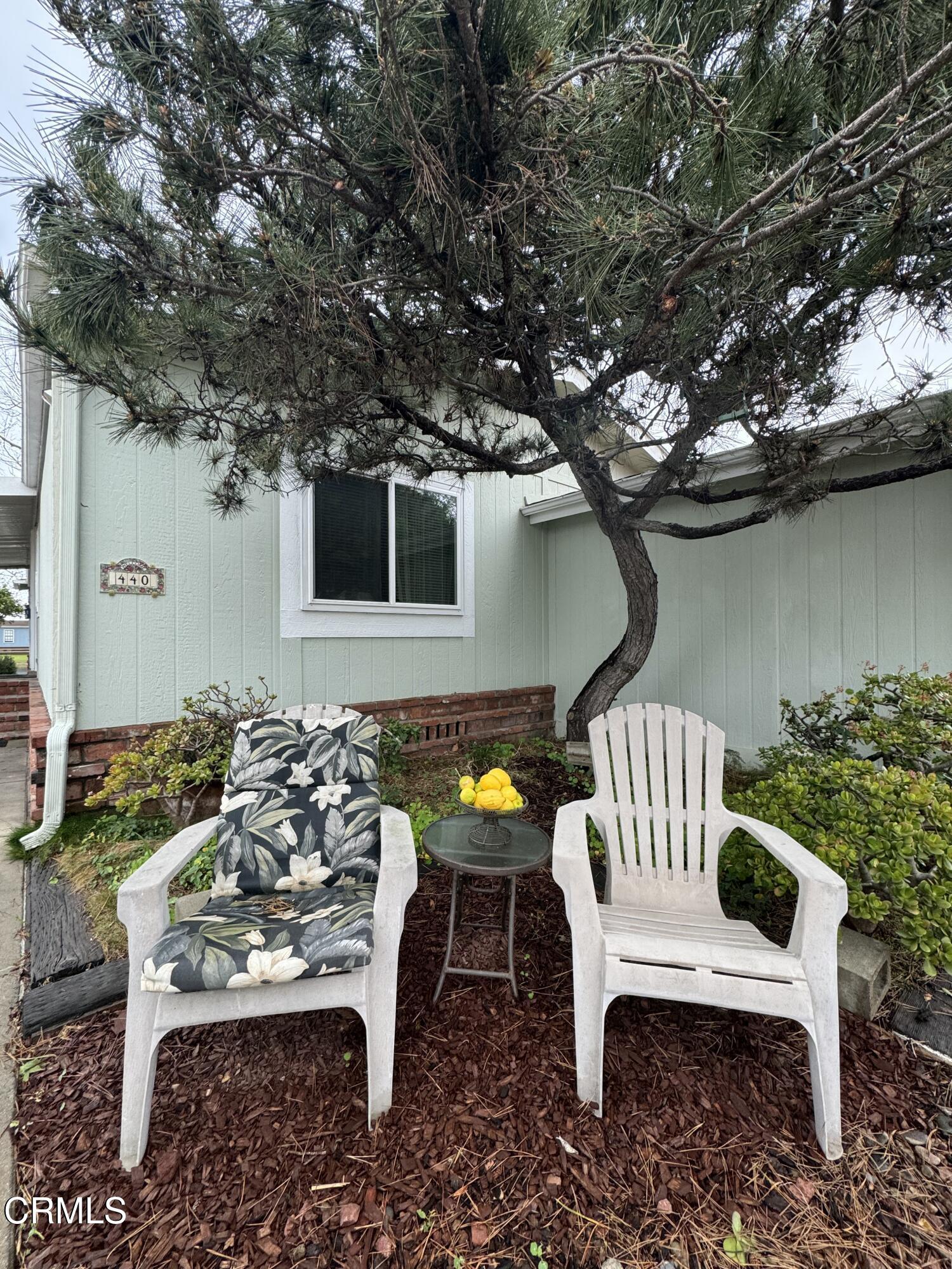440 Dewberry Lane, Unit 105 Oxnard, CA 93036 - Photo 60 of 75 a view of a chairs and table in backyard of the house