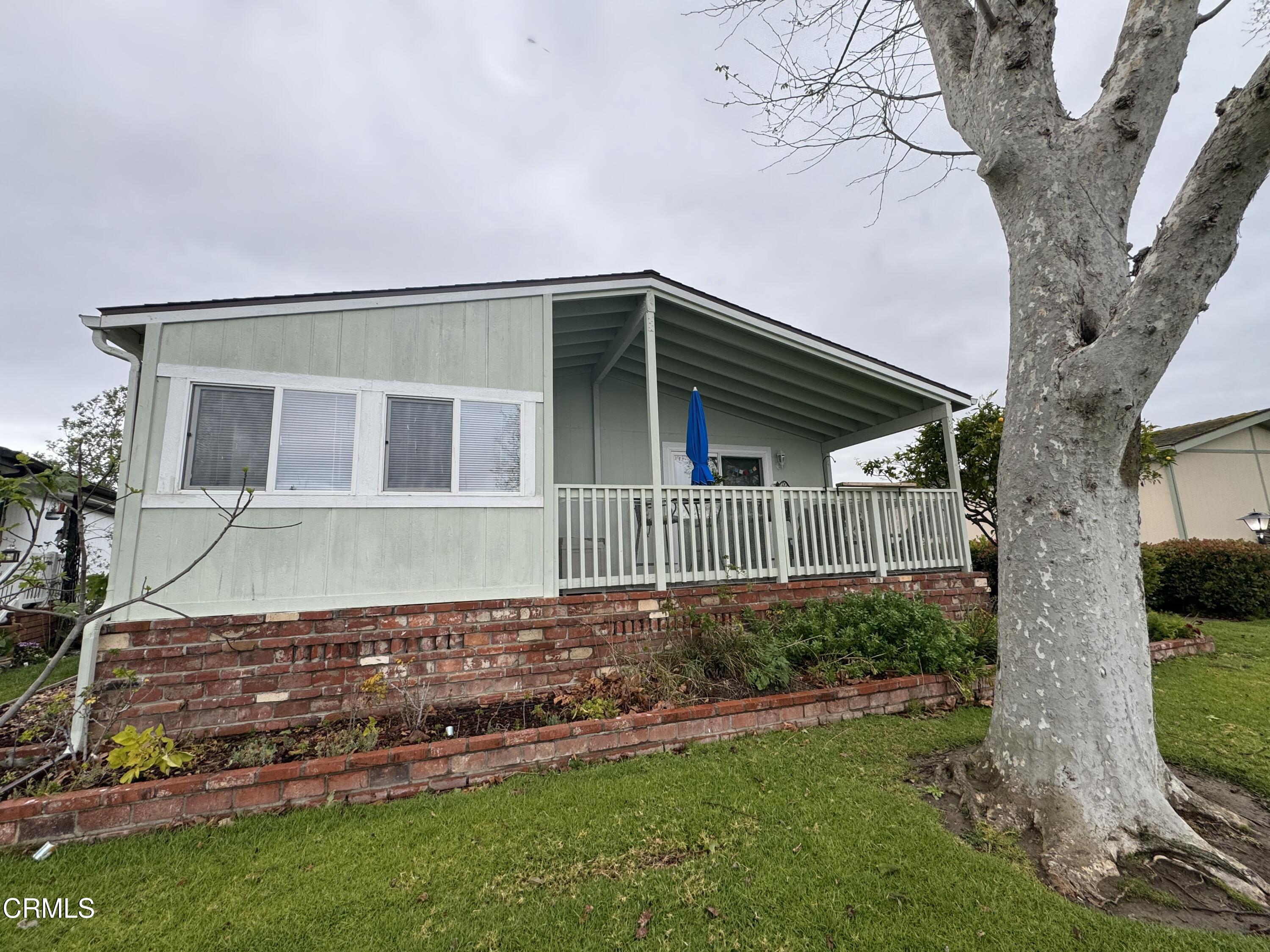 440 Dewberry Lane, Unit 105 Oxnard, CA 93036 - Photo 68 of 75 a front view of a house with a yard and garage