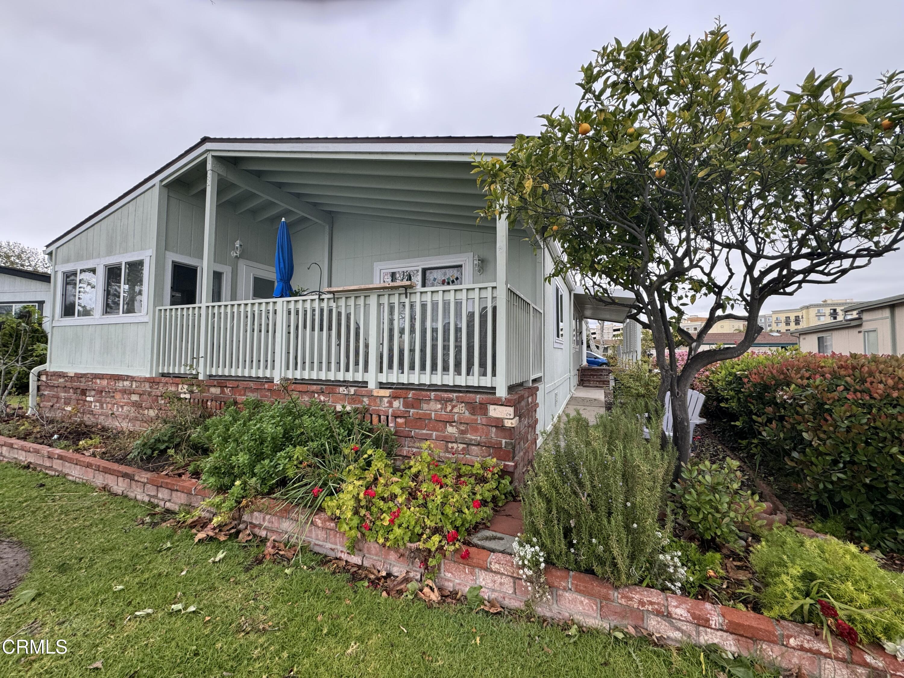 440 Dewberry Lane, Unit 105 Oxnard, CA 93036 - Photo 70 of 75 a front view of a house with a garden