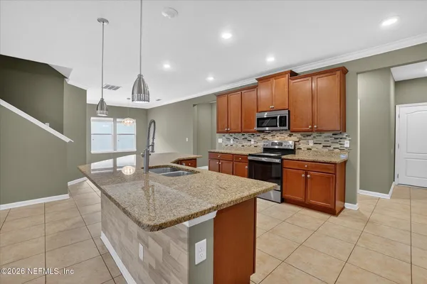 a kitchen with stainless steel appliances granite countertop a sink counter space cabinets and a counter top space