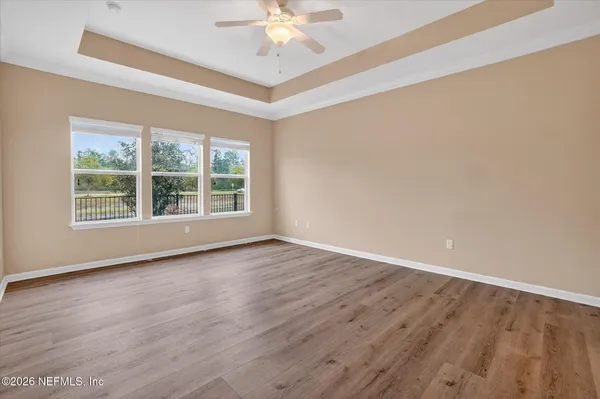 wooden floor in an empty room with a window
