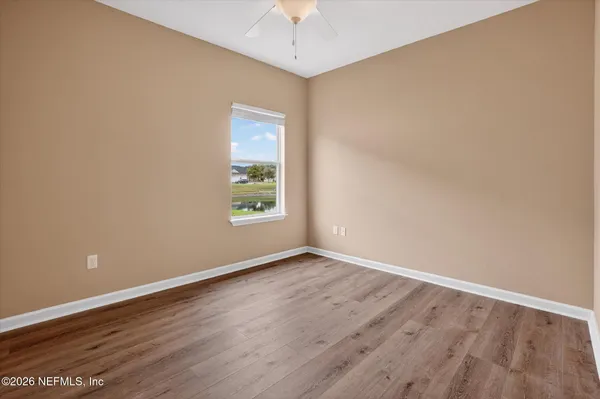 a view of an empty room with wooden floor
