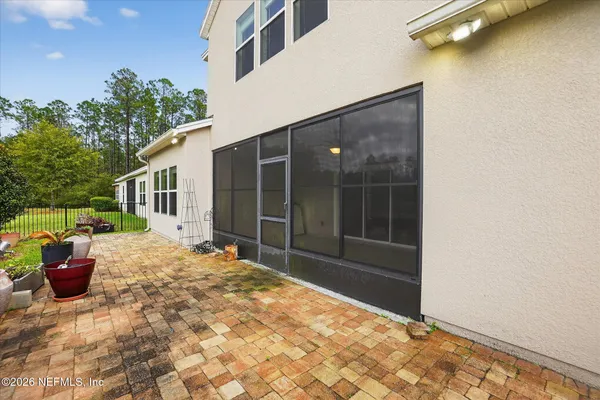 a view of a balcony with two chairs and a potted plant