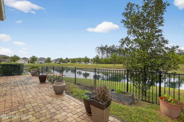 a view of a house with a yard and sitting area