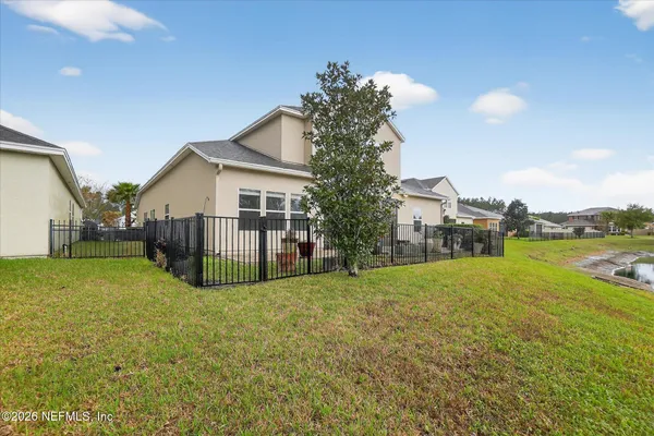 a view of a house with a yard and deck