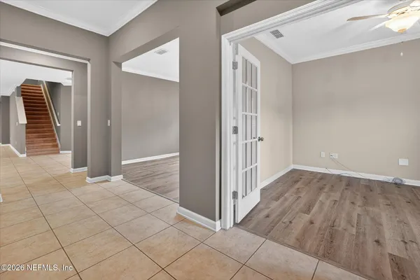 an empty room with wooden floor and cabinet
