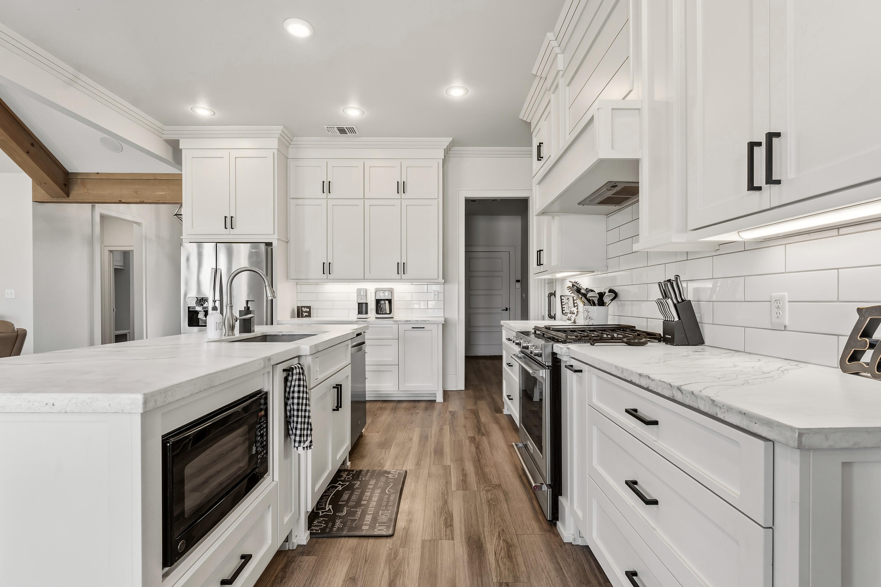 1113 16th Street Shallowater, TX 79363 - Photo 11 of 33 a kitchen with stainless steel appliances white cabinets a sink a stove a refrigerator and white cabinets