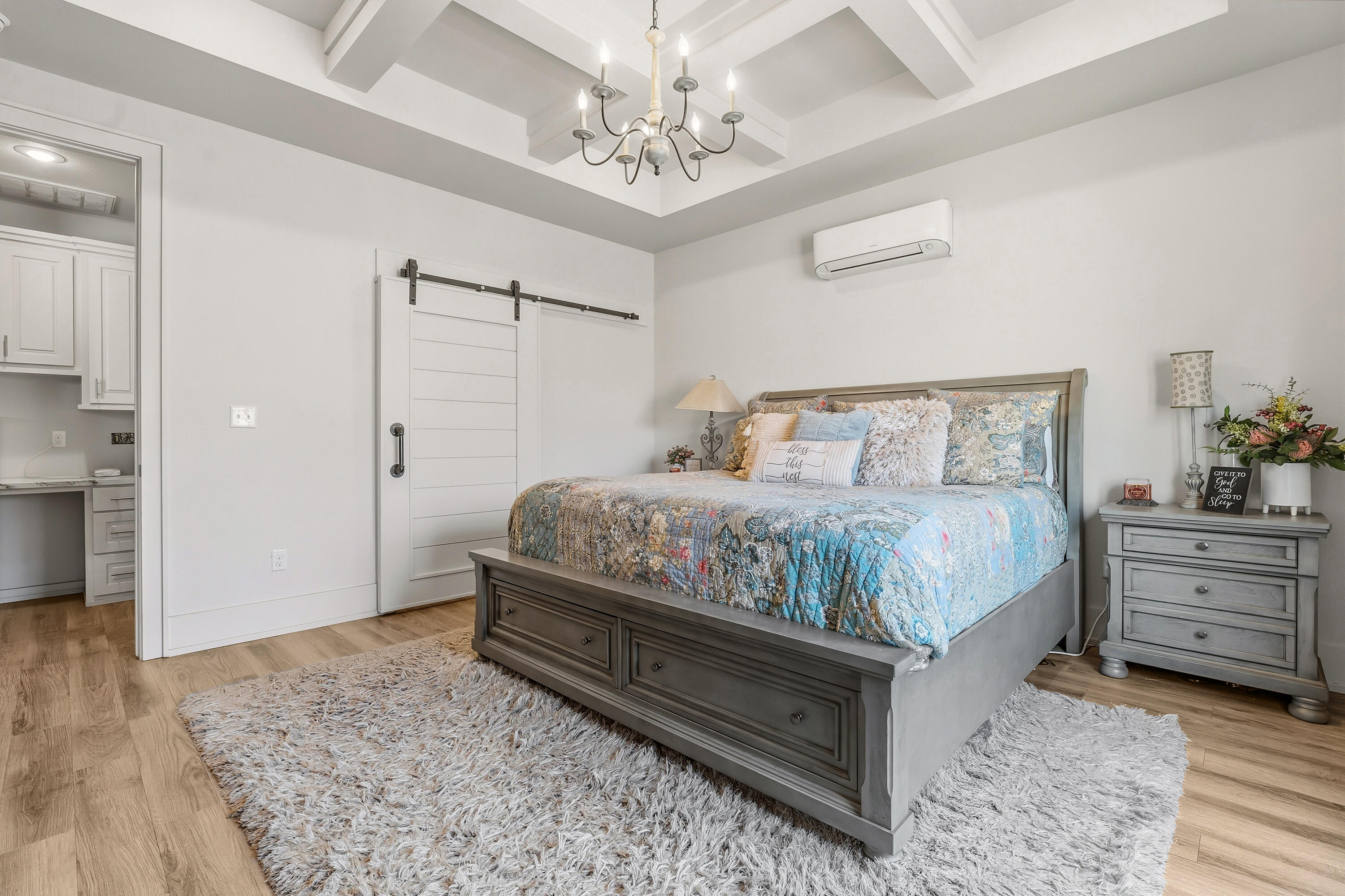 1113 16th Street Shallowater, TX 79363 - Photo 17 of 33 a bedroom with a bed and a chandelier