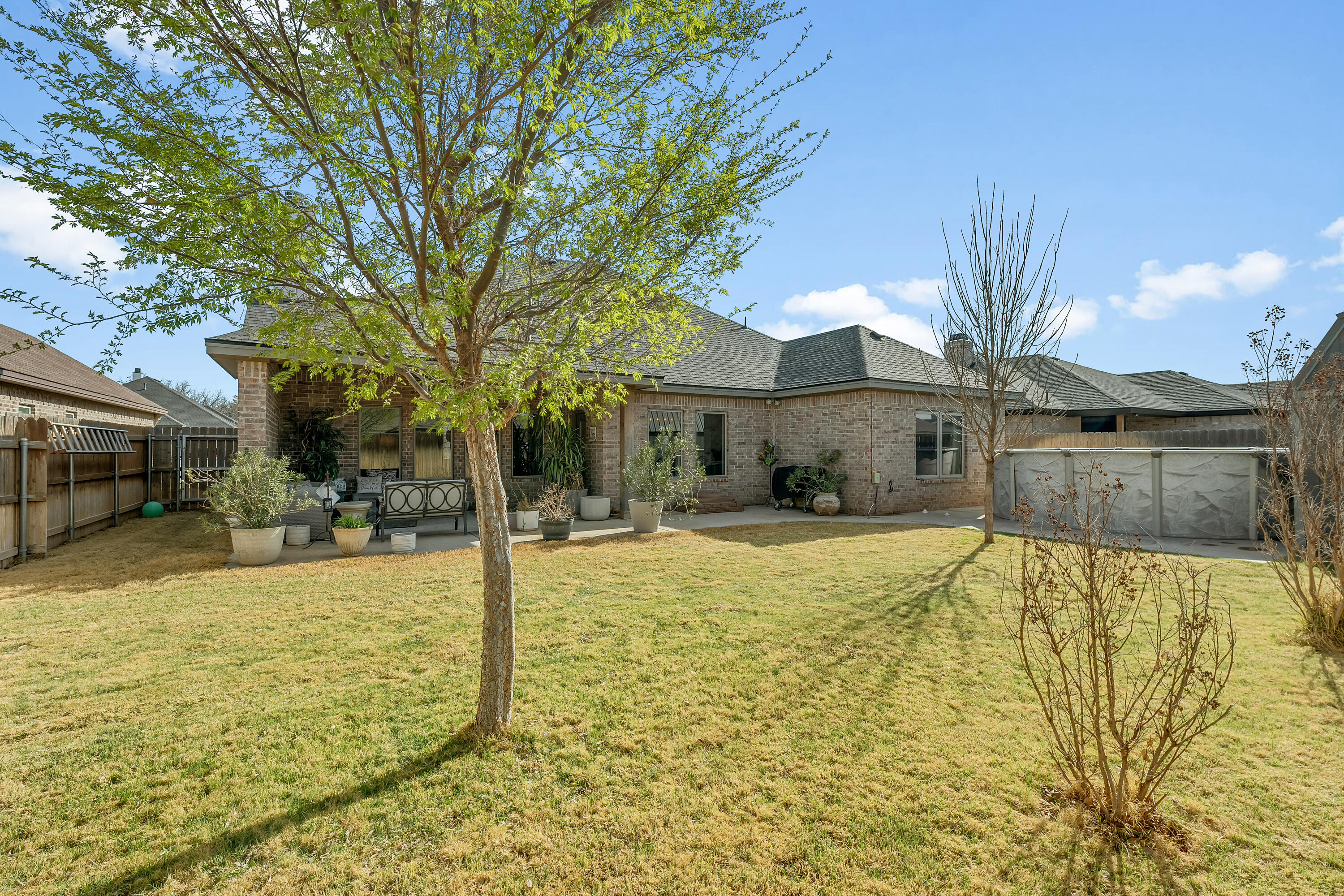 1113 16th Street Shallowater, TX 79363 - Photo 32 of 33 a view of swimming pool with table and chairs under an umbrella