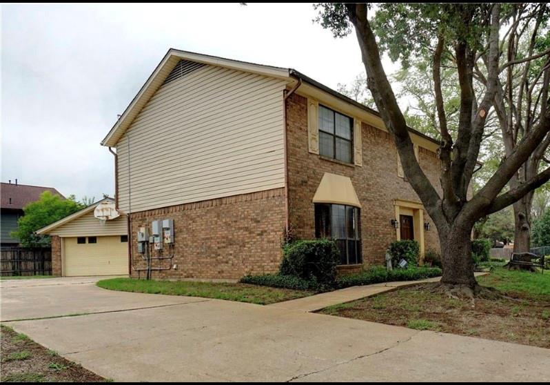 3261 Princess Street Bedford, TX 76021 - Photo 1 of 1 a front view of a house with a yard and garage