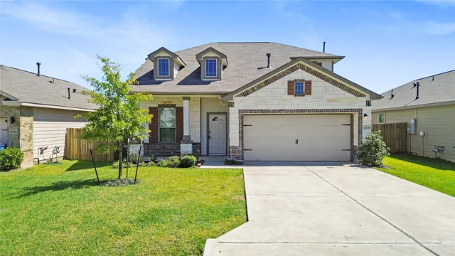 a view of a white house with a big yard and potted plants