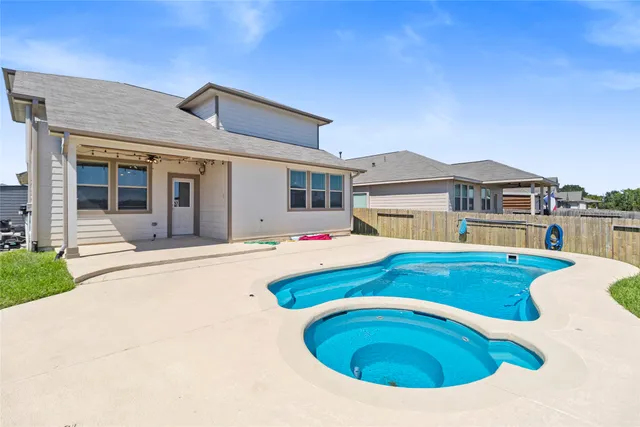 an aerial view of a house with a swimming pool yard and outdoor seating