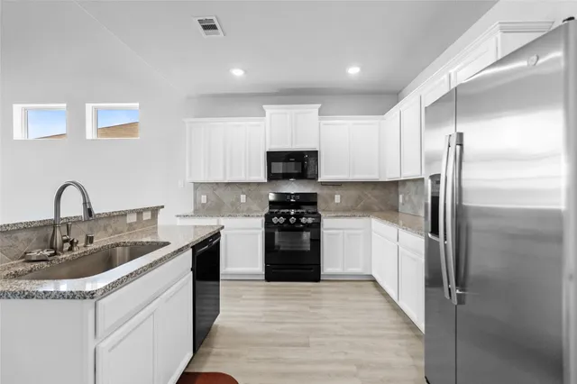 a kitchen with a sink and a refrigerator