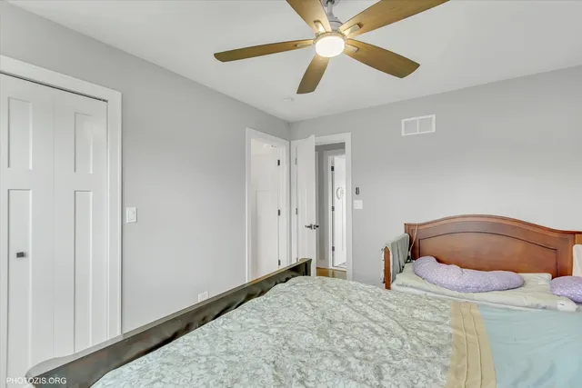 a bedroom with a bed and a desk