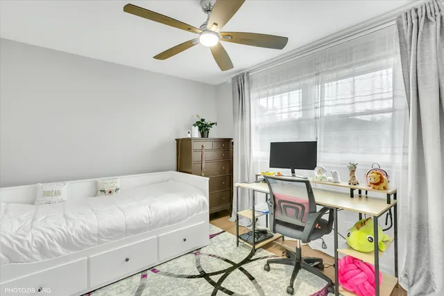 a workspace with furniture and ceiling fan