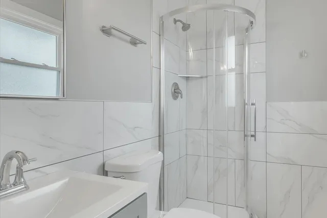 a white toilet sitting next to a bathroom sink