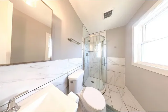 a bathroom with a bathtub and shower