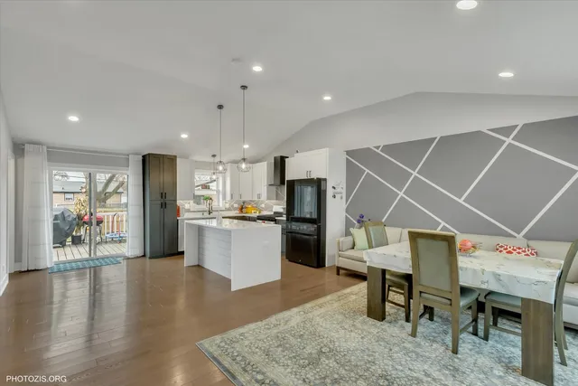 a living room with furniture and kitchen view