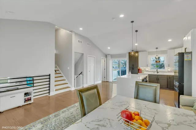 a kitchen with sink and chairs