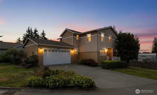 a front view of a house with a yard and garage