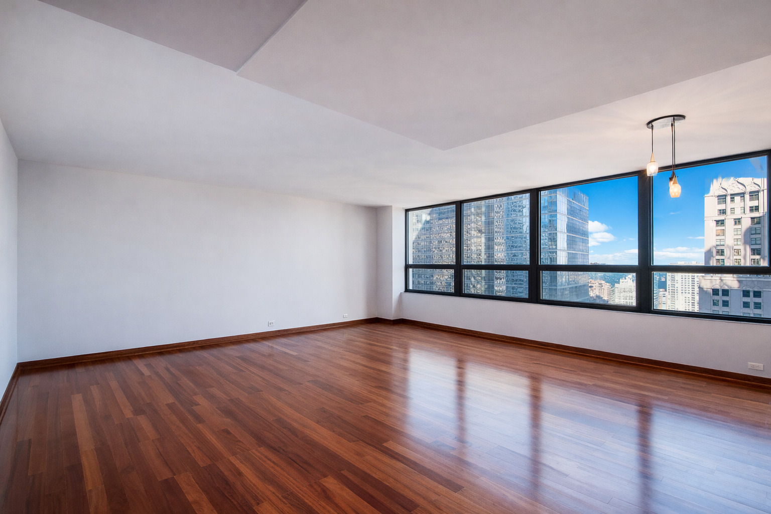 400 East Ohio Street, Unit 2902 Chicago, IL 60611 - Photo 4 of 33 a view of an empty room with wooden floor and a window