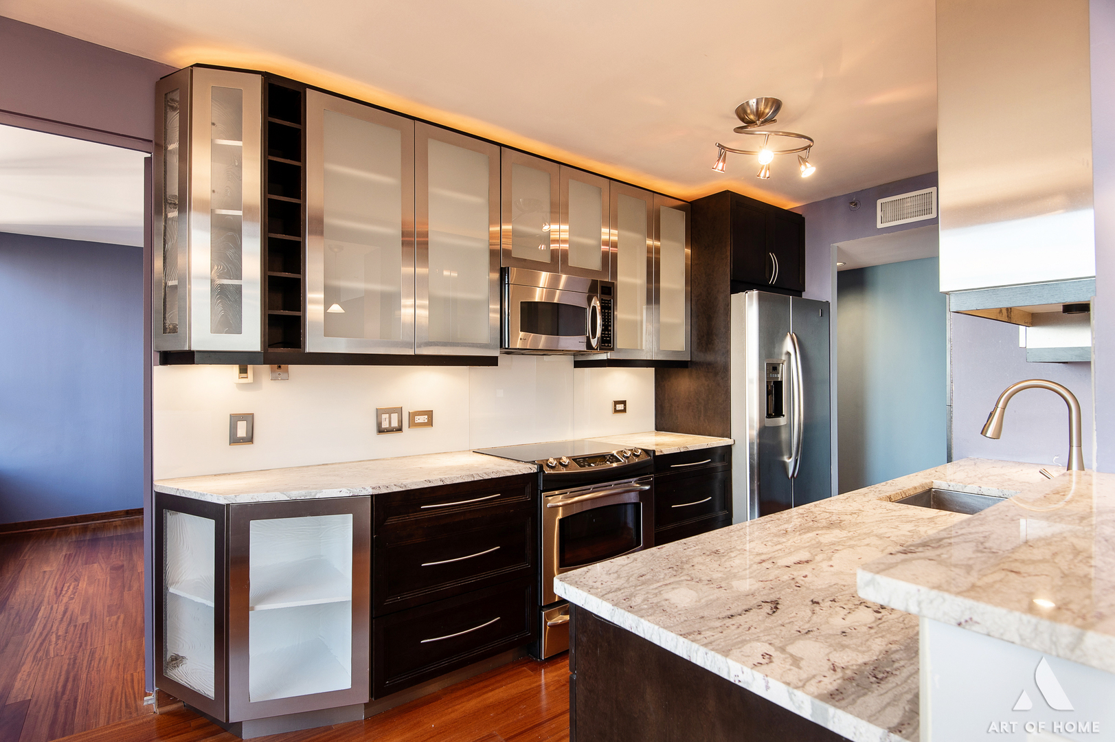 400 East Ohio Street, Unit 2902 Chicago, IL 60611 - Photo 10 of 33 a kitchen with stainless steel appliances kitchen island a cabinets and wooden floor